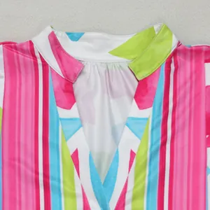 Close-up of V-neck collar on a vibrant multi-color floral print summer dress