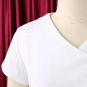 Close-up detail of a modern white V-neck short-sleeved women's top displayed on a mannequin