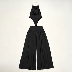 Elegant black two-piece set featuring halter neck top and wide leg pants flat lay