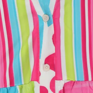 Macro detail shot showing colorful vertical stripes and buttons of an elegant V-neck dress