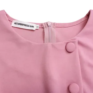 Close-up detail showing the round neckline and buttons of a pink high-waisted dress