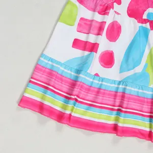 Close-up detail of the colorful floral print and fabric hem on this patchwork short dress
