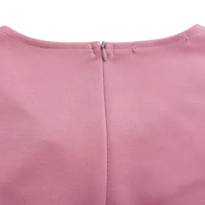 Close-up detail of invisible zipper and fine stitching on the back of a pink dress