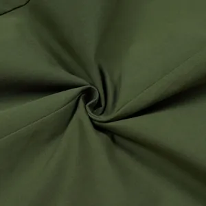 Macro detail view of high-quality olive green twill fabric texture for casual trousers