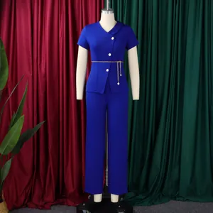 Detailed view of a royal blue two-piece set featuring gold buttons and chain belt