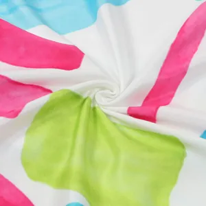 Close-up of vibrant floral print and soft fabric texture on a V-neck mini dress