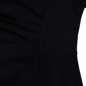 Detailed macro view showing the pleated V-neck design and fabric texture of a black dress