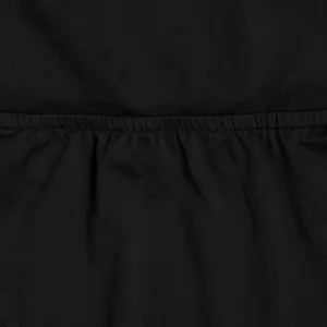 High-quality macro detail of pleated black fabric waist for elegant two-piece set
