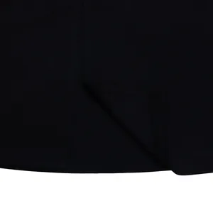 Close-up view of black dress fabric highlighting the stitching and hem craftsmanship.