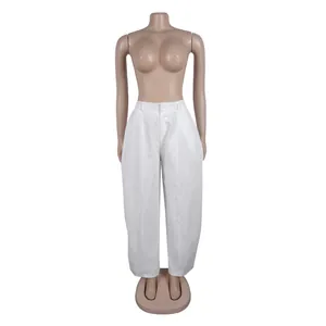Detail view of white wide-leg trousers on mannequin showing relaxed fit and commuter style.