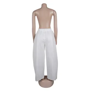 Detailed rear view of minimalist white elegant commuter loose wide leg trousers for women