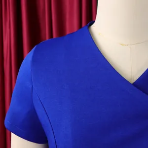Close-up detail of a bright blue V-neck short sleeve top showing fabric texture