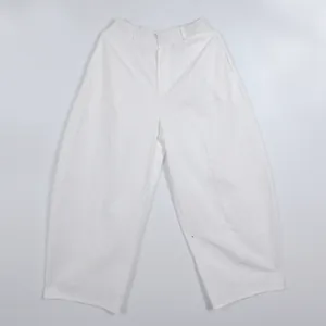 High-waisted minimalist white wide-leg trousers with a loose commuter silhouette