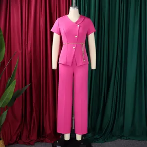 Pink short-sleeved top with button detail and matching straight pants on a mannequin.