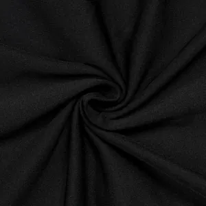 Macro detail of high-quality black pleated fabric texture for an elegant two-piece set