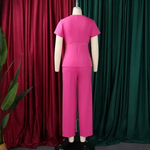 Detailed back view of a vibrant pink short-sleeve top and matching trousers set on a mannequin
