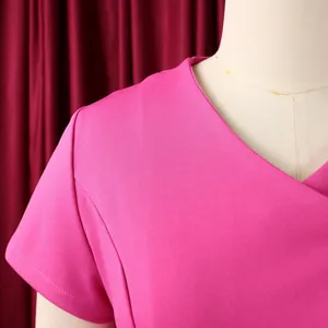 Close-up detail of the V-neckline and shoulder of a magenta short-sleeved top