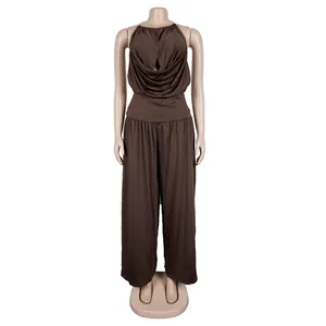 Detail view of elegant brown halter neck top and draped wide-leg trousers on a mannequin