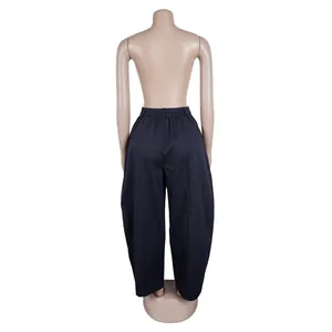 Back view of high-waist navy blue loose-fit barrel trousers showing fabric drape
