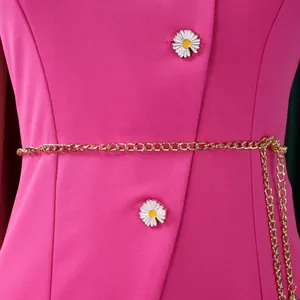 Close-up detail view of a pink summer suit jacket with daisy buttons and gold chain belt