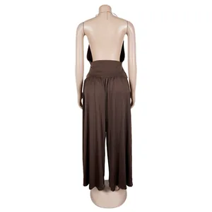 Detail view showing the back design of brown halter top and pleated wide-leg pants