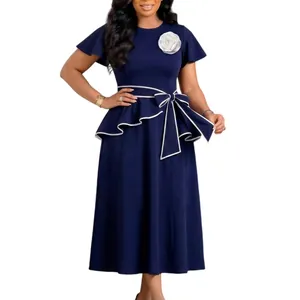 Detailed view of a navy blue African style dress with white flower and peplum waist tie