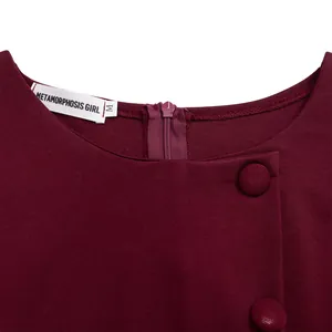 Detail view of burgundy dress neckline with zipper and decorative buttons