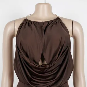 Close-up detail of a brown halter neck top featuring elegant pleated draping and a V-neckline