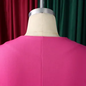 Close-up detail of the back seam on a vibrant pink short-sleeved fashion top