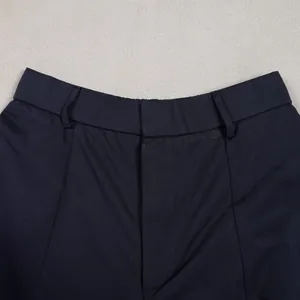 Detailed view of the waistband and front fly design on navy blue loose casual trousers