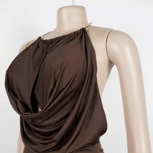 Close-up detail of the elegant brown pleated fabric with a metallic halter neck ring