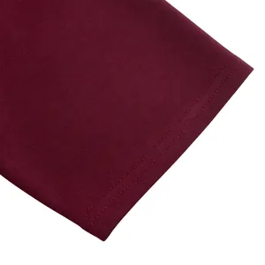 Macro view of burgundy fabric texture and neat double-needle stitching detail on dress hem