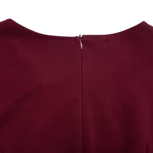 Close-up view of the invisible back zipper detail on a burgundy fake two-piece dress