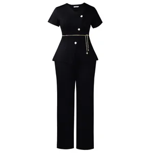 Detailed view of black two-piece set featuring daisy buttons and a gold chain belt
