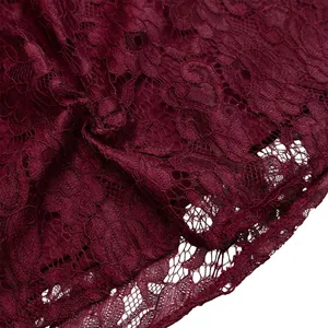 Macro view of intricate dark burgundy floral lace fabric texture on this elegant dress