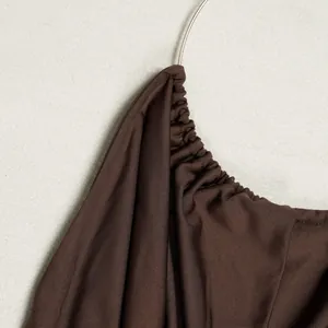 Detailed close-up showing the elegant dark brown ruched fabric of a halter neck top