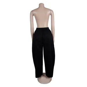 Back view of black wide-leg trousers on mannequin with loose silhouette