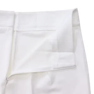 Close-up detail of high-quality white trousers with a hidden zipper and neat stitching.