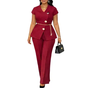 Elegant wine red two-piece suit with gold buttons and wide-leg trousers.