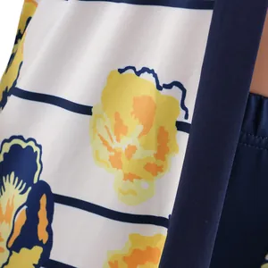 Detail of vibrant yellow and navy floral print on two-piece cardigan set fabric