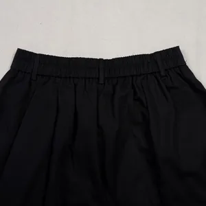 Detailed macro view of the elasticated waistband and belt loops on black casual loose trousers