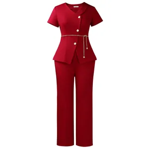 Professional elegant red two-piece suit featuring daisy buttons and a gold chain belt