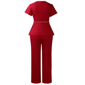 Detailed back view of red short-sleeve peplum top and trousers set with gold chain belt