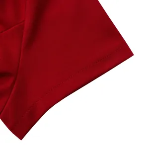 Detail view of the red short-sleeved top sleeve hem with neat double-needle stitching