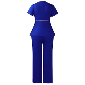 Back view of elegant royal blue short-sleeved peplum top and pants set with gold chain
