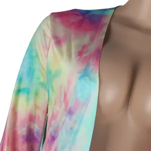 Detailed close-up of vibrant tie-dye print on sexy long sleeve clubwear cardigan.