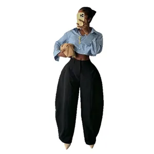 Stylish high-waisted black wide-leg trousers with an exaggerated barrel silhouette.