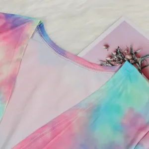 Close-up detail of vibrant tie-dye fabric and neckline stitching of a clubwear cardigan.