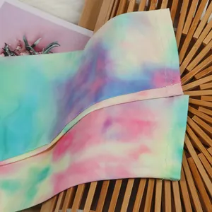 Detailed macro shot of vibrant tie-dye print fabric showing soft texture and fine stitching