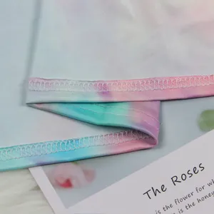 Detailed close-up showing the pastel tie-dye fabric and stitching of the cardigan set